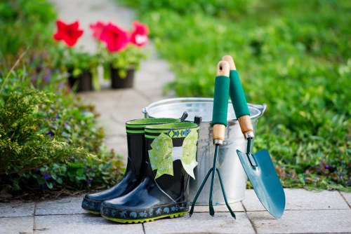 Team member preparing lawn mower on a Chiswick garden